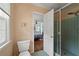 Neutral-toned bathroom showcasing a glass-enclosed shower and doorway leading to the bedroom at 3912 Edenton Ne Ct, Brookhaven, GA 30319