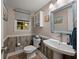 Charming powder room with wood paneling, unique mirror and decorative accents at 3912 Edenton Ne Ct, Brookhaven, GA 30319