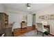 Bright bedroom with hardwood floors, two chairs, and a desk with open shelving at 3912 Edenton Ne Ct, Brookhaven, GA 30319