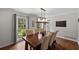 Elegant dining room featuring hardwood floors, modern light fixture, and neutral tones at 3912 Edenton Ne Ct, Brookhaven, GA 30319