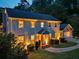 Illuminated two-story home showing front yard, manicured bushes, basketball hoop over garage, and inviting walkway to the front door at 3912 Edenton Ne Ct, Brookhaven, GA 30319