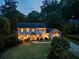 Two-story home featuring a well-maintained front lawn, mature trees, and an attached garage at dusk at 3912 Edenton Ne Ct, Brookhaven, GA 30319