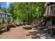 Inviting stone patio with brick fire pit, lounge chairs, and manicured landscaping at 3912 Edenton Ne Ct, Brookhaven, GA 30319