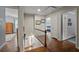 Upstairs hallway featuring hardwood floors, a staircase, and multiple doorways leading to other rooms at 3912 Edenton Ne Ct, Brookhaven, GA 30319
