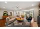 Spacious living room featuring hardwood floors, recessed lighting, and modern ceiling fan with large windows providing natural light at 3912 Edenton Ne Ct, Brookhaven, GA 30319