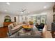 Spacious living room featuring hardwood floors, recessed lighting, and modern ceiling fan with large windows providing natural light at 3912 Edenton Ne Ct, Brookhaven, GA 30319