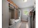 Functional mudroom includes built-in storage, seating, and laundry appliances at 3912 Edenton Ne Ct, Brookhaven, GA 30319