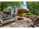 An outdoor patio featuring a fire pit, lounge chairs, and a screened porch at 3912 Edenton Ne Ct, Brookhaven, GA 30319