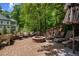 Backyard patio with brick pavers, featuring firepit and lounge seating at 3912 Edenton Ne Ct, Brookhaven, GA 30319