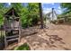 Backyard wooden playset with slide and climbing area, nestled in a lush, green landscape behind the house at 3912 Edenton Ne Ct, Brookhaven, GA 30319