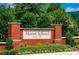 Marist School sign with brick columns, surrounded by lush greenery and flowers at 3912 Edenton Ne Ct, Brookhaven, GA 30319