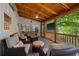 Relaxing screened-in porch with wood ceiling featuring comfortable seating and a TV at 3912 Edenton Ne Ct, Brookhaven, GA 30319