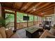 Inviting screened porch with wood ceiling featuring dining and living zones with a TV at 3912 Edenton Ne Ct, Brookhaven, GA 30319