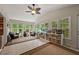 Bright sunroom filled with natural light, tile floor, multiple windows, and custom storage at 3912 Edenton Ne Ct, Brookhaven, GA 30319