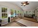 Bright sunroom filled with natural light, tile floor, multiple windows, and custom storage at 3912 Edenton Ne Ct, Brookhaven, GA 30319