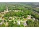 Aerial view of home showcasing lush landscaping and neighborhood amid green trees at 3935 Hamilton View Way, Dacula, GA 30019
