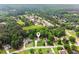 Aerial view of a neighborhood with tree-lined streets and lake nearby at 3935 Hamilton View Way, Dacula, GA 30019