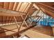 Unfinished attic featuring exposed beams and rafters, offering potential for customization and storage at 3935 Hamilton View Way, Dacula, GA 30019