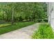Lush backyard with green lawn, mature trees, and natural privacy, a serene outdoor space at 3935 Hamilton View Way, Dacula, GA 30019