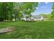 Spacious backyard with lush lawn and mature trees providing a serene outdoor retreat at 3935 Hamilton View Way, Dacula, GA 30019