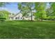 Large, green backyard with mature trees, offering space for outdoor activities and enjoyment at 3935 Hamilton View Way, Dacula, GA 30019