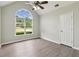 Vaulted bedroom with large window overlooking landscaped yard and mature trees at 3935 Hamilton View Way, Dacula, GA 30019
