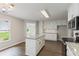 Kitchen with a large island, stainless appliances and bright lighting at 3935 Hamilton View Way, Dacula, GA 30019