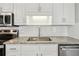 Close-up of the kitchen with granite counters and stainless steel appliances at 3935 Hamilton View Way, Dacula, GA 30019