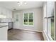 Bright kitchen features new stainless dishwasher and white cabinets near eat-in area at 3935 Hamilton View Way, Dacula, GA 30019