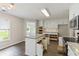 Bright kitchen featuring white cabinets, granite countertops and view to breakfast area at 3935 Hamilton View Way, Dacula, GA 30019