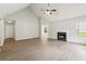 Spacious living room with fireplace, light wood-look floors, and neutral walls at 3935 Hamilton View Way, Dacula, GA 30019