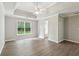 Spacious main bedroom with tray ceiling, ceiling fan and door to ensuite bath at 3935 Hamilton View Way, Dacula, GA 30019