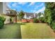 Large backyard boasts a wooden fence, mature trees, and a spacious lawn, providing privacy and tranquility at 1740 Ambercrest Pl, Buford, GA 30518