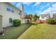 Spacious backyard featuring a deck, shed, a large lawn, and mature trees at 1740 Ambercrest Pl, Buford, GA 30518