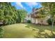 View of the spacious backyard with a deck, shed, and plenty of green space, perfect for outdoor enjoyment at 1740 Ambercrest Pl, Buford, GA 30518