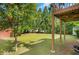 The backyard offers a large grassy area bordered by mature trees and a wooden fence at 1740 Ambercrest Pl, Buford, GA 30518