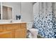 Bathroom with a maple vanity and blue patterned shower curtain at 1740 Ambercrest Pl, Buford, GA 30518