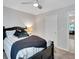 Bedroom with a dark wood bed frame, plush pillows and ceiling fan at 1740 Ambercrest Pl, Buford, GA 30518