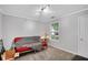 Neutral bedroom with a red futon, throw blanket and light colored carpet at 1740 Ambercrest Pl, Buford, GA 30518