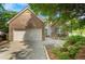 Charming brick home with a two-car garage, green shutters and a landscaped yard at 1740 Ambercrest Pl, Buford, GA 30518