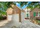 Charming brick home with a two-car garage, green door and shutters and a landscaped yard at 1740 Ambercrest Pl, Buford, GA 30518