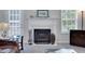 Living room fireplace with white mantle, hearth and decorative fire screen at 1740 Ambercrest Pl, Buford, GA 30518