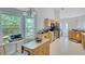 Bright eat-in kitchen with natural wood cabinets, island and stainless steel appliances at 1740 Ambercrest Pl, Buford, GA 30518
