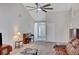 Bright living room featuring vaulted ceiling, ceiling fan, and elegant piano near the front door at 1740 Ambercrest Pl, Buford, GA 30518