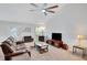 Spacious living room with fireplace, plush carpeting, ceiling fan and lots of natural light at 1740 Ambercrest Pl, Buford, GA 30518