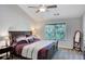 Bedroom with a dark wood bed frame, plush pillows and ceiling fan at 1740 Ambercrest Pl, Buford, GA 30518