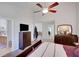 Bright main bedroom with a ceiling fan, neutral walls, and an ensuite bathroom at 1740 Ambercrest Pl, Buford, GA 30518