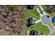 Aerial view of a home surrounded by green grass, trees and other homes within the community at 205 Carrington Pt, Canton, GA 30115