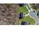 Aerial view of a home in a cul-de-sac surrounded by trees with a defined property line at 205 Carrington Pt, Canton, GA 30115