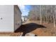 Side view of the house showing the backyard space and treeline in the distance at 205 Carrington Pt, Canton, GA 30115